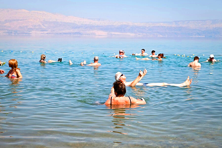 Travelers enjoying the Dead Sea on their guided tour