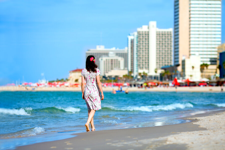 Young Woman Walking on the Beach in Tel-Aviv, Israel.