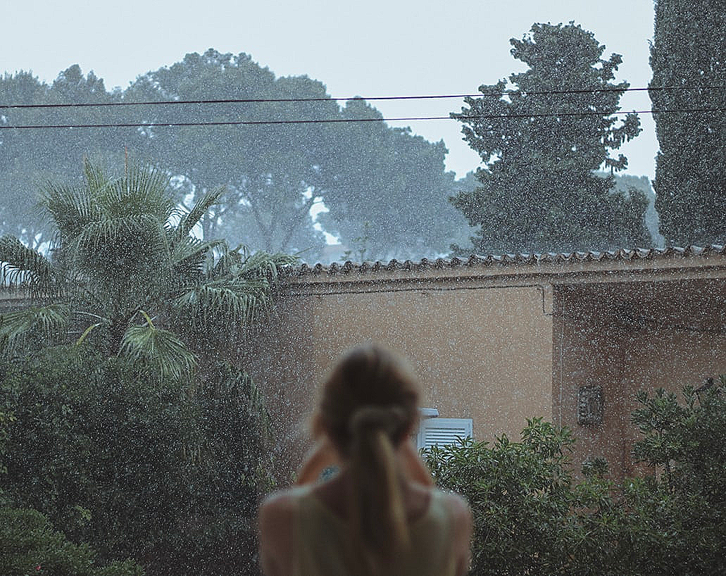 A girl watching the rain