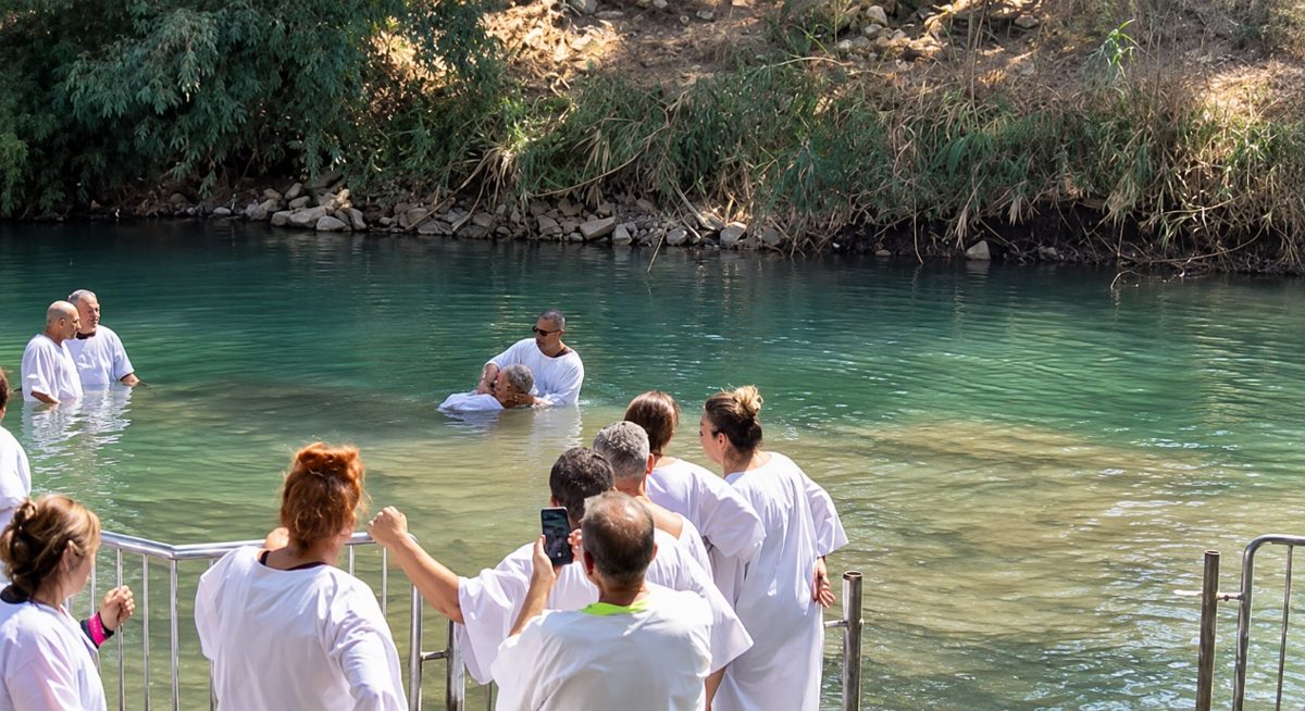 Pilgrims taking part in a baptismal service at Yardenit on the Jordan River