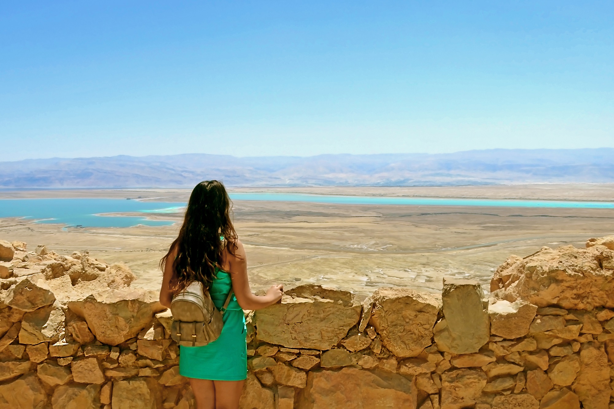A tourist in Masada looking at the Dead Sea, Israel