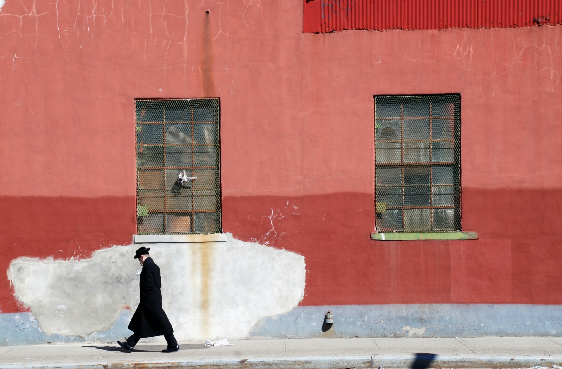 An Orthodox Jew against the background of the red wall