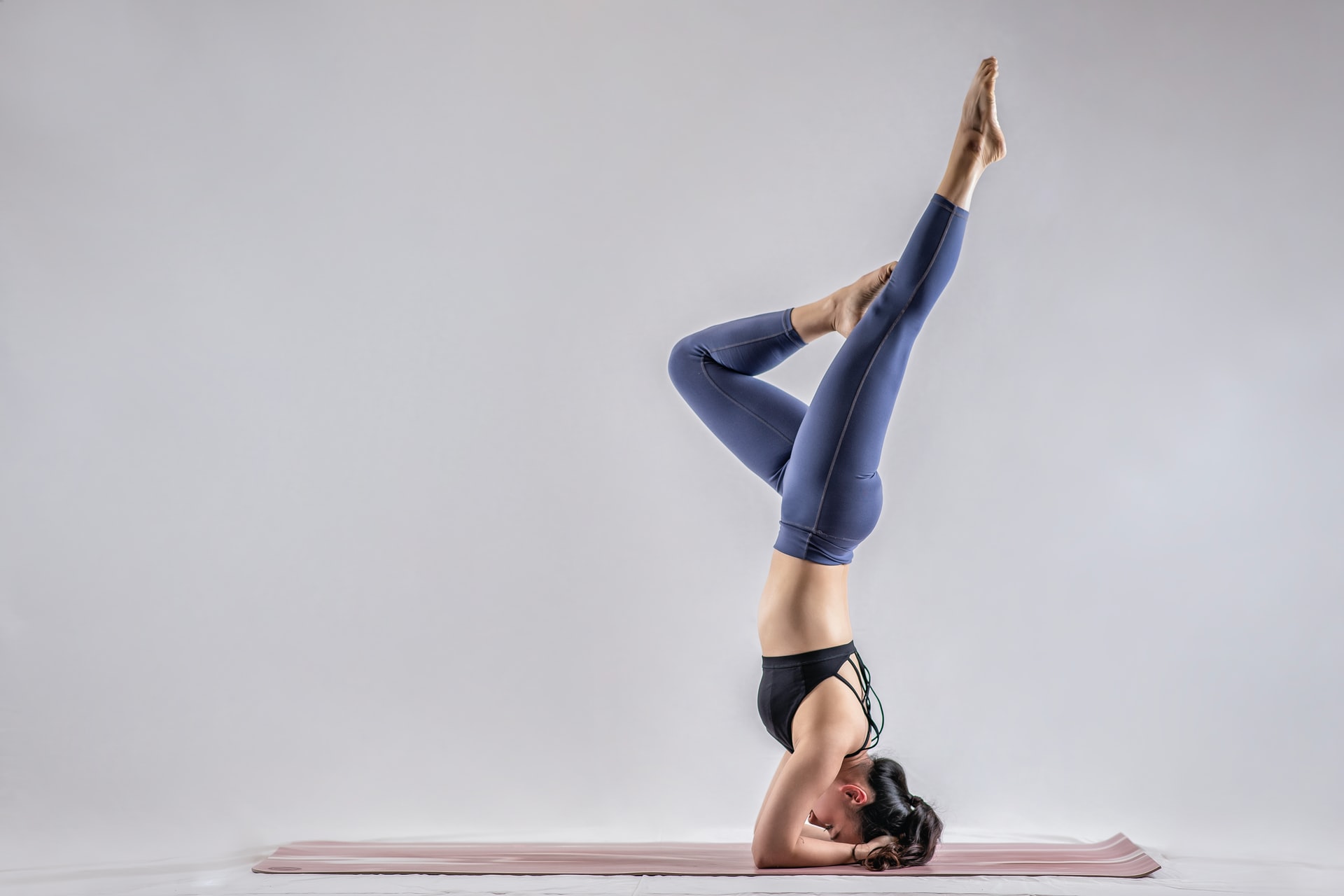 A woman doing advanced yoga pose