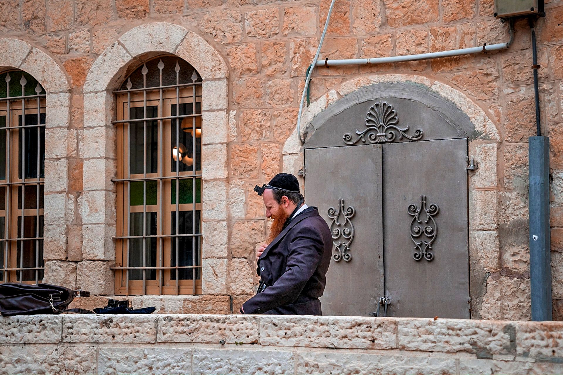 Religious Jew with tefillin on his forehead prays in the Old City of Jerusalem