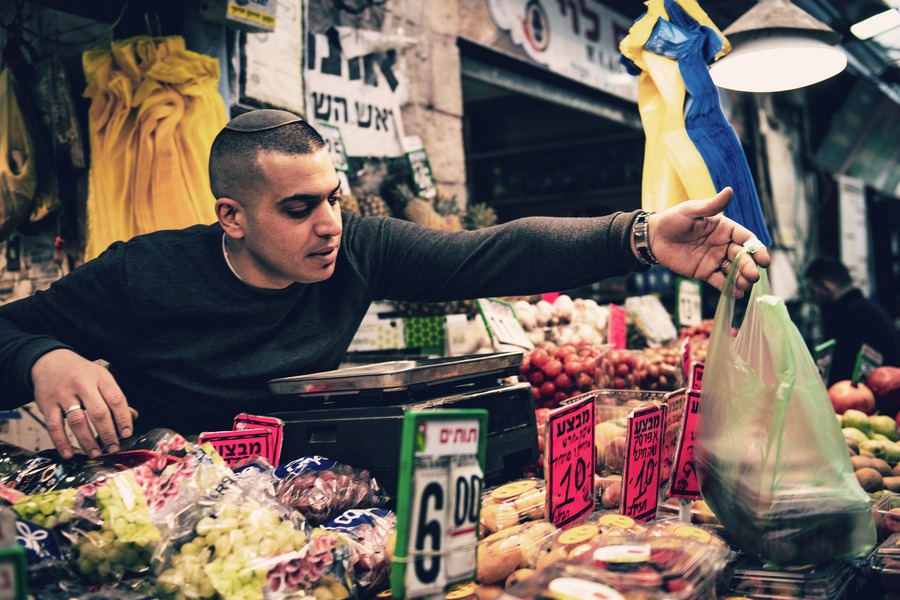 Man selling fruits at Mahane Yehuda Market, Jerusalem