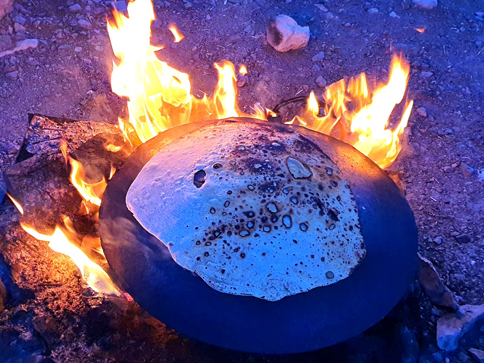 Traditional Bedouin flatbread getting baked on a tabun in the Negev desert