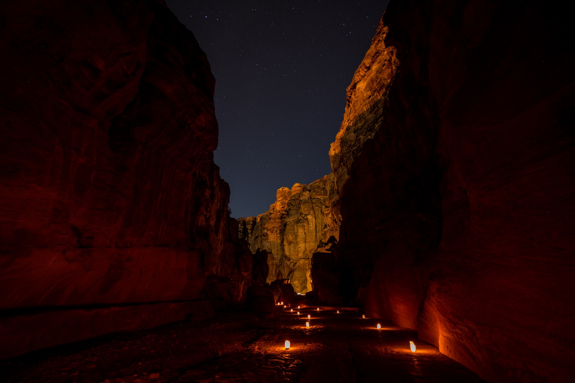 Petra by Night- The Siq gorge is glowing in the light of candles and stars