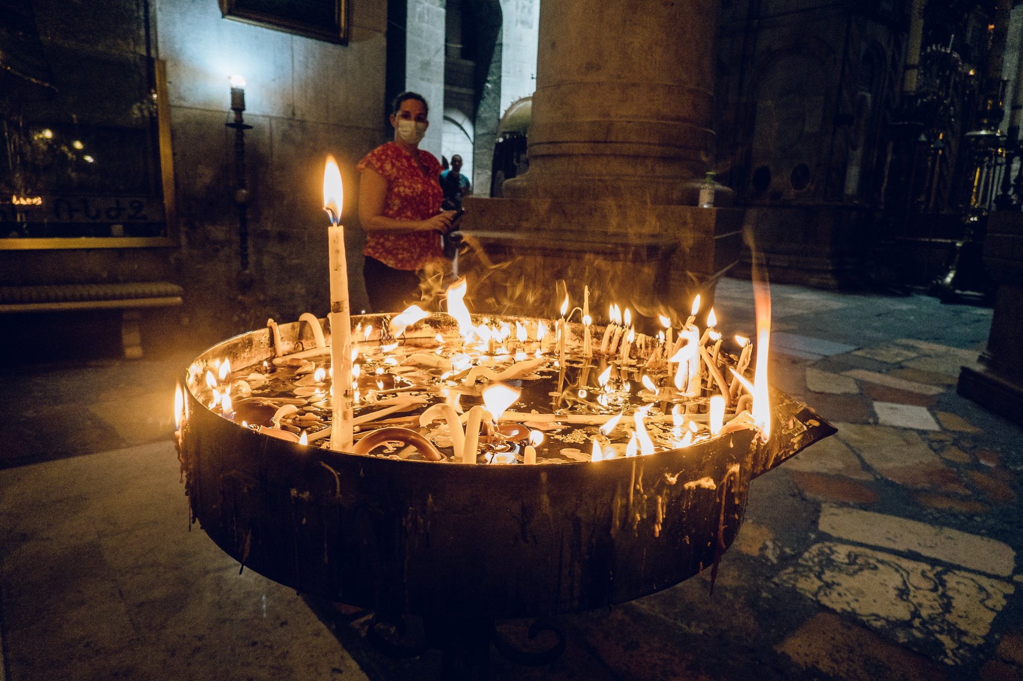 Lighting candles in the Church of the Holy Sepulchre