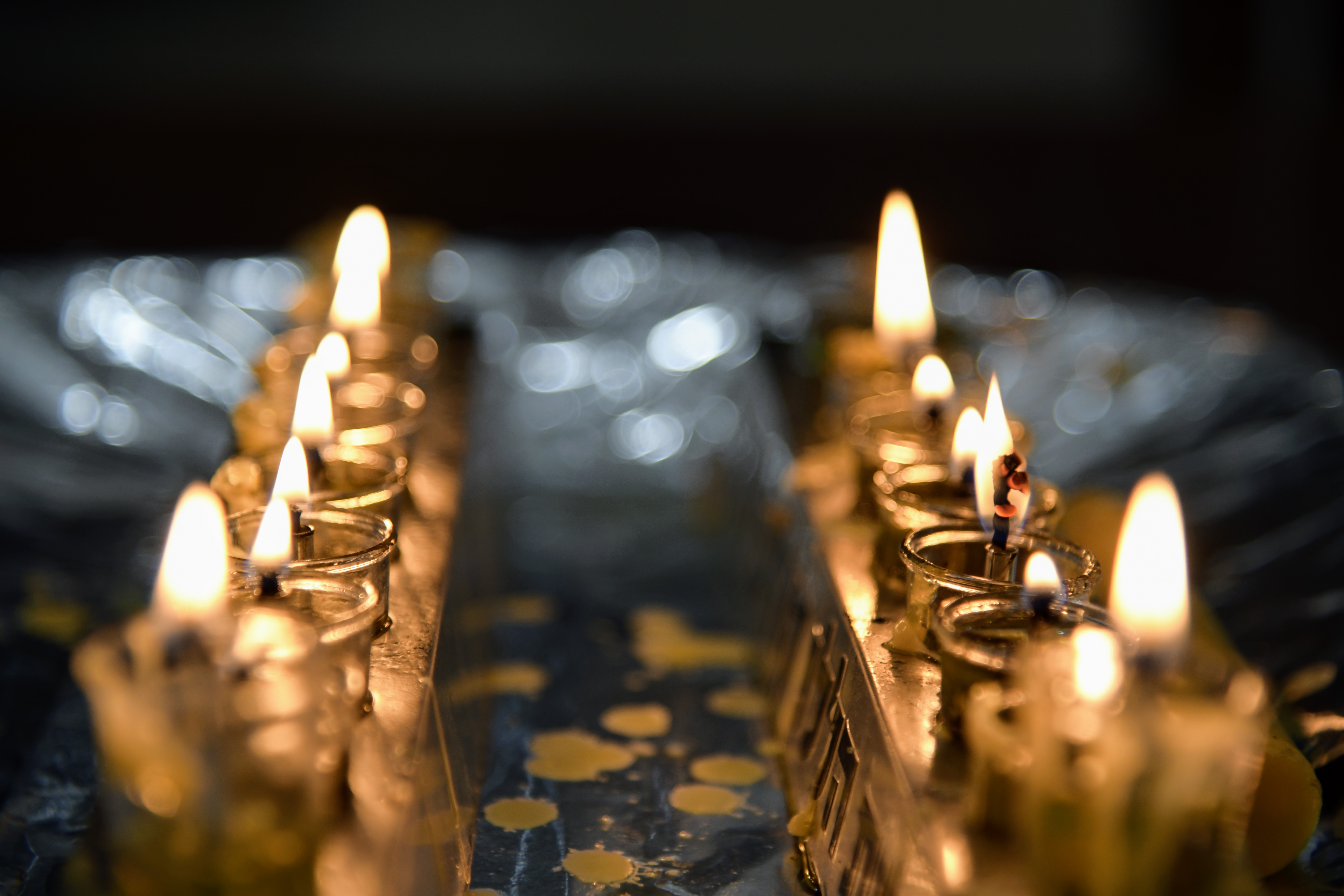 Two Hanukkah menoras with lit candles