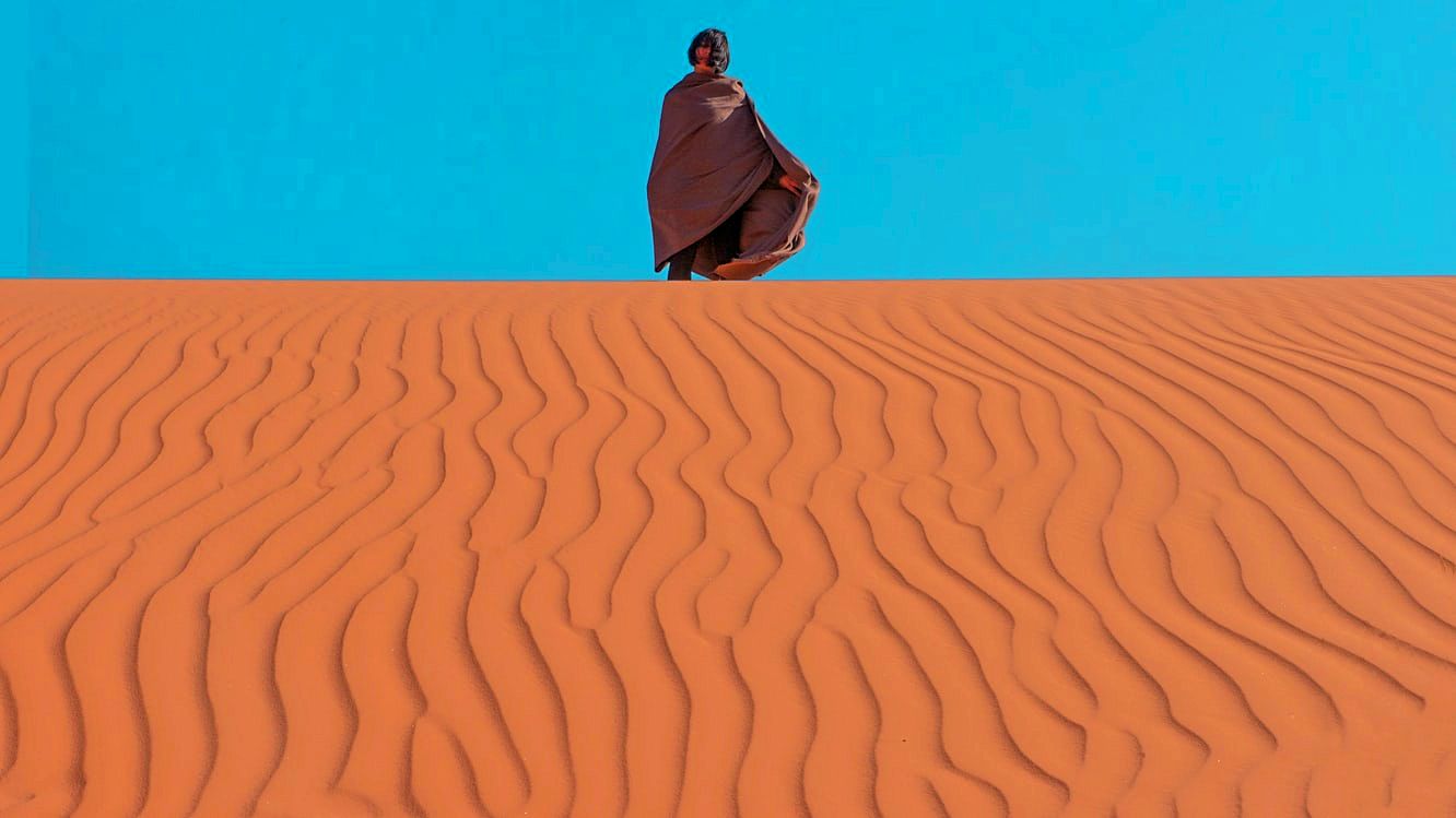 Woman in the dunes of Wadi Rum, Jordan