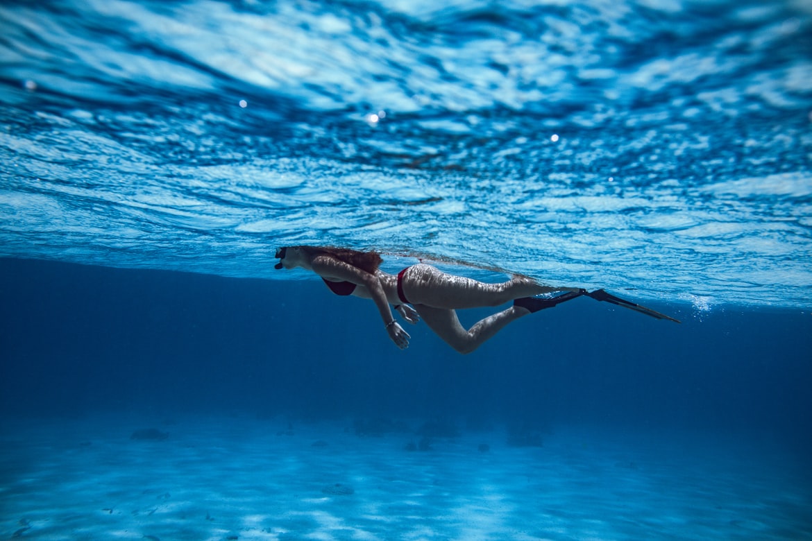 A freediver-girl snorkelling across the sea