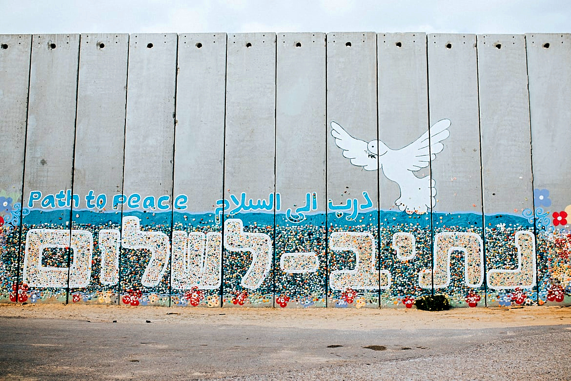 A wall at Netiv HaAsara facing the Gaza border reads the words “Path to Peace” in Hebrew, Arabic, and English