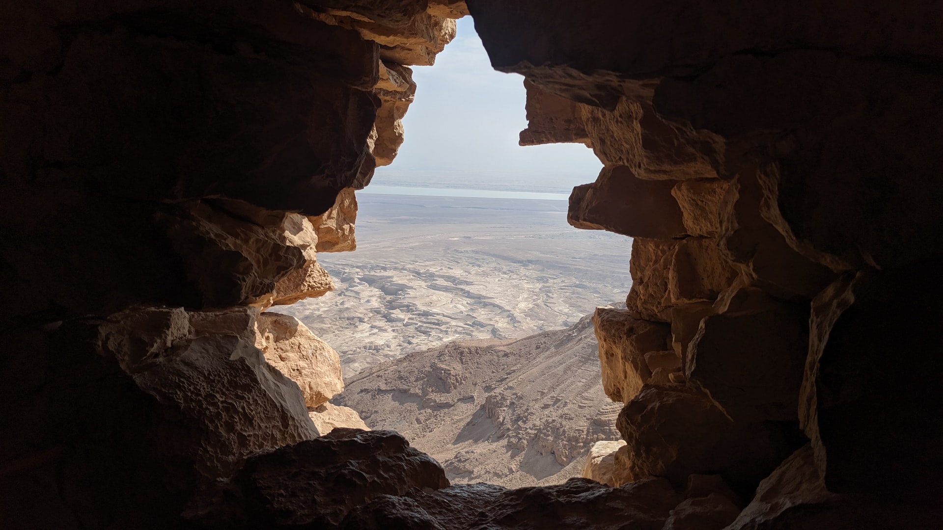 Looking through an ancient stone wall opening at the Masada ruins in Israel