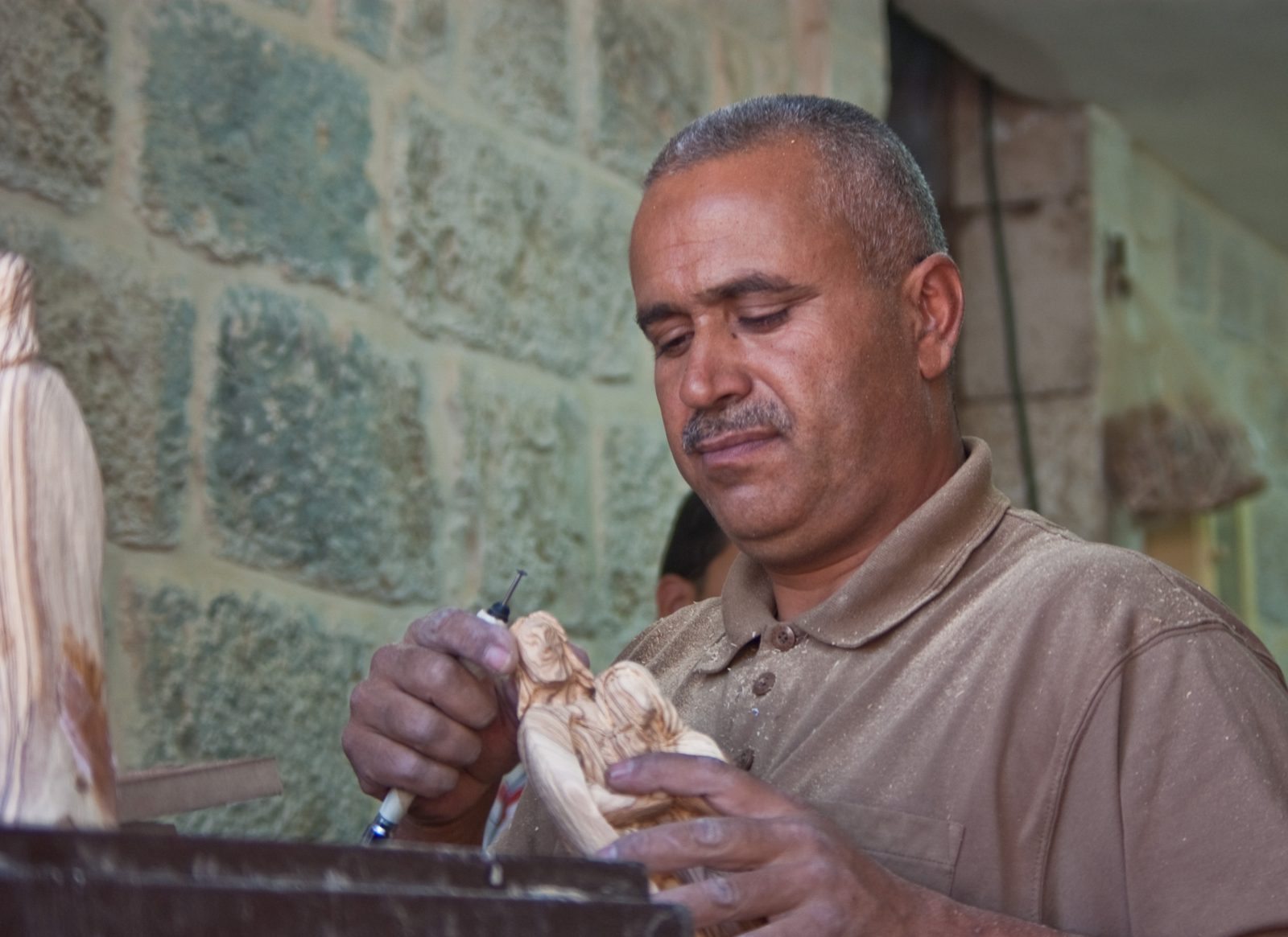 An artisan carving olive wood in Bethlehem. An artisan carving olive wood in Bethlehem.