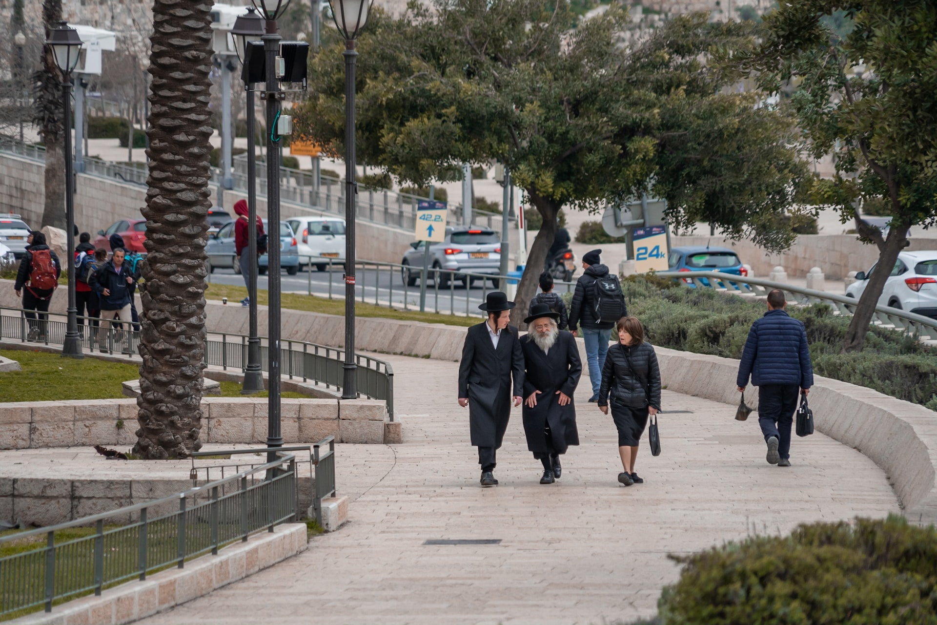 Family of religious Jews dressed in black walks through the Old City of Jerusalem
