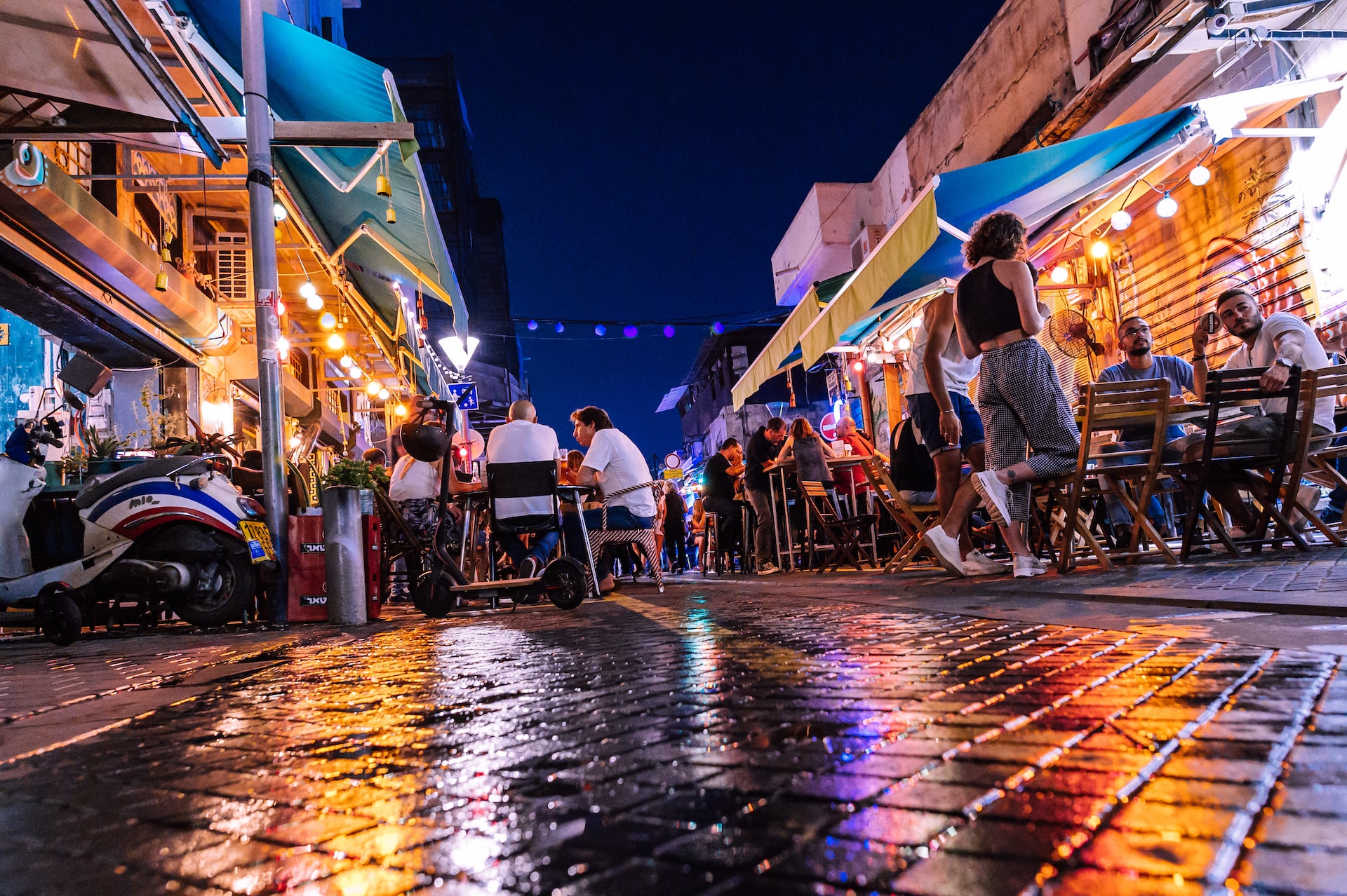 People eating at a restaurant in the street in Tel Aviv