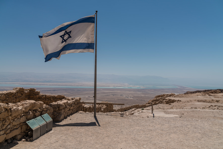 Israeli flag against the background of Masada fortress 
