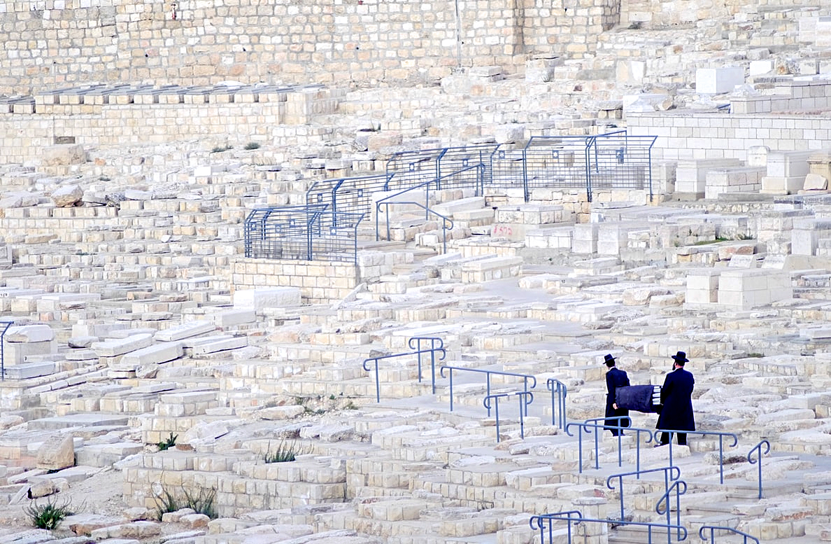 Two Orthodox Jews burying a genizah at the Jewish Cemetery on Mount Olives