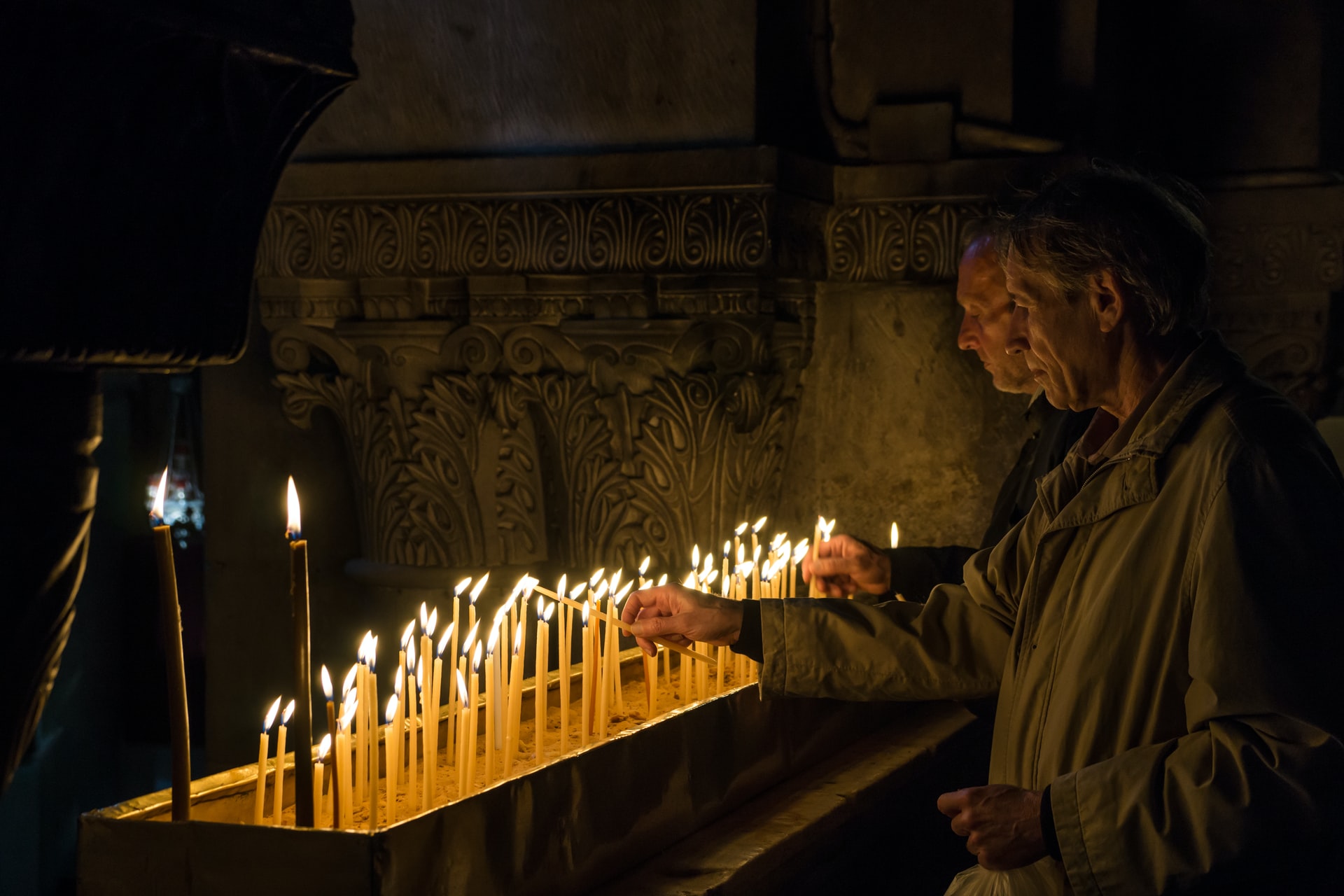 Pilgrims lighting candles in the church of the Holy Sepulchre in Jerusalem