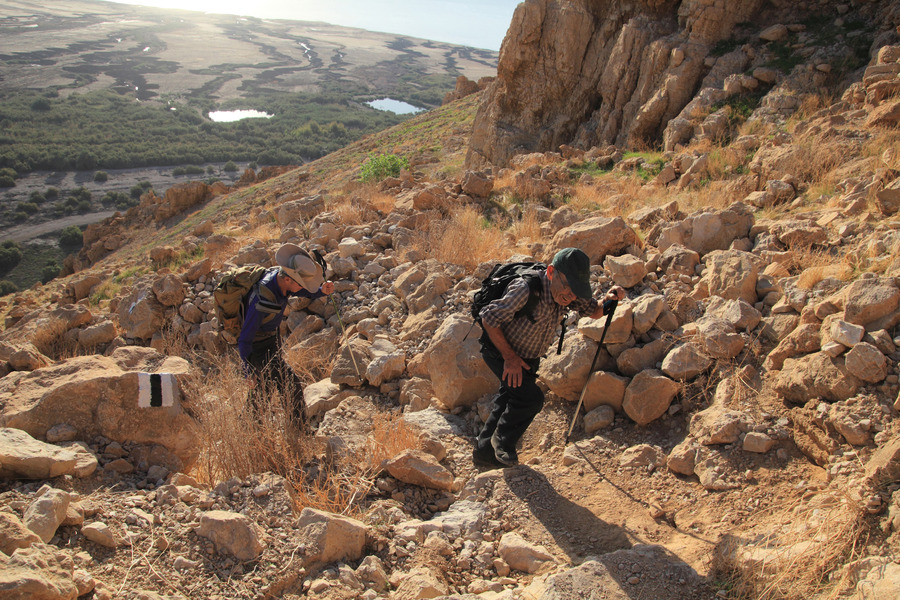 Hikers climbing the cliff overlooking Einot Tzukim and the Dead Sea.